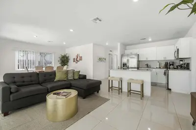 a living room with a couch and a kitchen at Modern 4BR Retreat with Private Pool - Near Brickell in Miami
