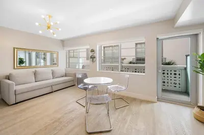 a living room with a couch and a table and chairs at Heart of Ocean Drive - Studio - Rooftop Pool in Miami Beach