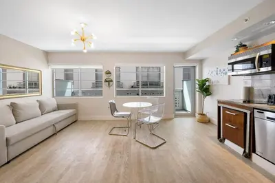 a living room with a couch and a table at Heart of Ocean Drive - Studio - Rooftop Pool in Miami Beach