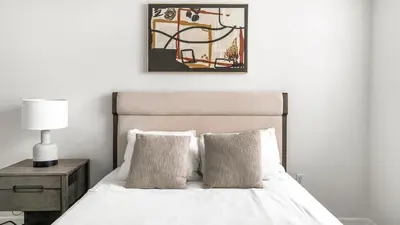 a bedroom with a bed with a picture on the wall at Landing Apartments - Fort Lauderdale in Fort Lauderdale