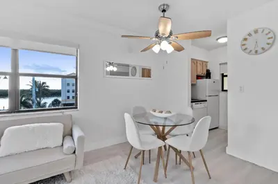 a dining room with a ceiling fan and a table and chairs at Amazing 1bed on Hollywood Beach Boardwalk W Pool in Hollywood