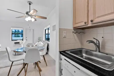 a kitchen with a sink and a table at Amazing 1bed on Hollywood Beach Boardwalk W Pool in Hollywood