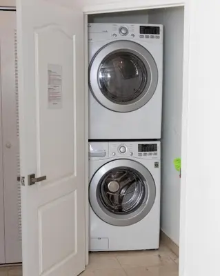 two washing machines stacked on top of each other at The CAROLINE I at King David in Sunny Isles Beach in Sunny Isles Beach