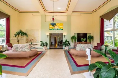 a large living room with two couches and plants at Tropical South Beach Condo - Pool & Miami Beach Vibes in Miami Beach