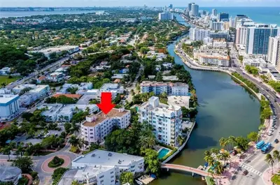 an aerial view of a city with a red arrow on a building at Tropical South Beach Condo - Pool & Miami Beach Vibes in Miami Beach
