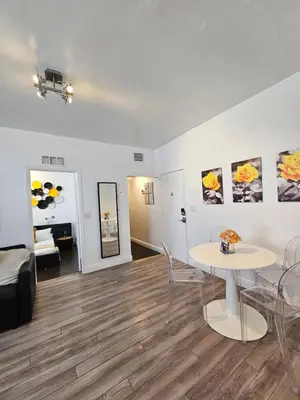 a living room with a table and chairs and a couch at Nice 2 bedrooms near the beach in Miami Beach