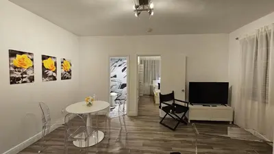 a living room with a table and a television at Nice 2 bedrooms near the beach in Miami Beach