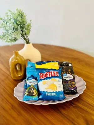 a plate with packets of crisps and chips on a table at Balcony 2BR Apartment with Free Parking near Freedom Park & Brickell in Miami