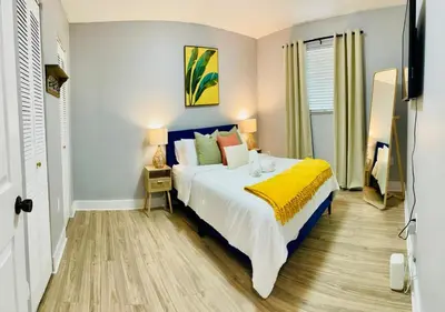 a bedroom with a bed with a yellow blanket at Balcony 2BR Apartment with Free Parking near Freedom Park & Brickell in Miami