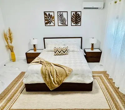 a bedroom with a large bed and two lamps at Earth-Toned Escape, Stylish Stay in Miami