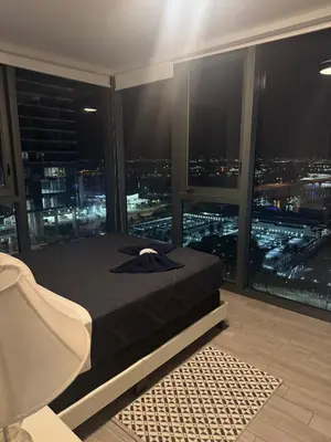 a bedroom with a bed with a view of a city at Spectacular corner 2BDR Downtown Miami in Miami