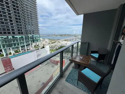 a balcony with a table and chairs on a building at Spectacular corner 2BDR Downtown Miami in Miami