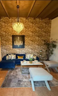 a living room with a blue couch and a stone wall at 4bdrm Waterfront salt water Pool home with Outdoor theater Game Rm Make up vanities in every room Perfect for Game days and concerts trips to Miami Hard rock stadium and hotel 15 mins away in Miramar