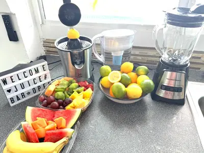 two bowls of fruit on a counter next to a blender at 4bdrm Waterfront salt water Pool home with Outdoor theater Game Rm Make up vanities in every room Perfect for Game days and concerts trips to Miami Hard rock stadium and hotel 15 mins away in Miramar