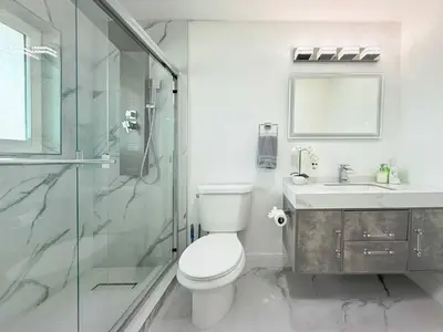 a bathroom with a toilet and a shower and a sink at Ultimate Getaway Private Pool & Games Near Beach in Fort Lauderdale