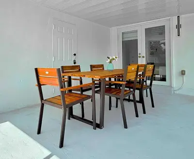 a wooden dining room table and chairs with a vase on it at Ultimate Getaway Private Pool & Games Near Beach in Fort Lauderdale
