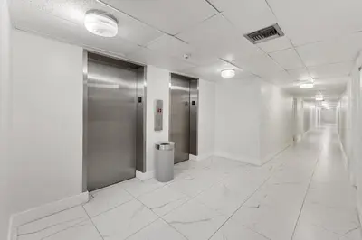 a hallway with elevators in a building with white floors at 2BR-2BA with Pool Gym Beach Marbella Tower in Sunny Isles Beach