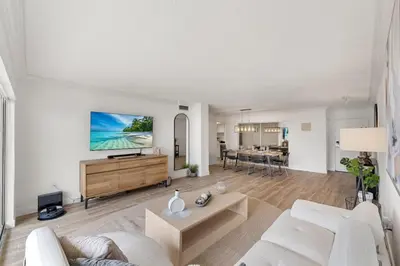 a living room with a white couch and a table at 2BR-2BA with Pool Gym Beach Marbella Tower in Sunny Isles Beach