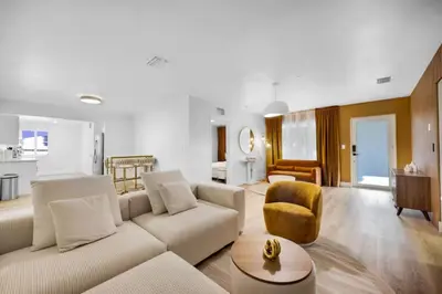 a living room with a couch and a chair at Hidden Miami Oasis Heated Pool and Games in Golden Glades