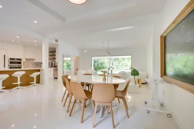 a dining room with a table and chairs at Biscayne Park Urban Oasis with Lush Backyard! in Biscayne Park