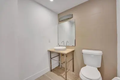 a bathroom with a white toilet and a sink at Spacious 2BR in Miami Bay Views plus Balcony in Miami