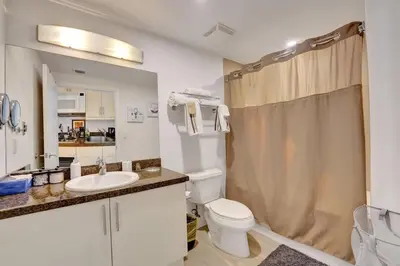 a bathroom with a toilet and a sink and a shower at Arya Hotel Studio Views plus Kitchenette plus Parking in Miami