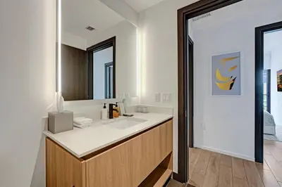 a bathroom with a sink and a mirror at Miami 3BR Retreat City and Bay Views in Miami