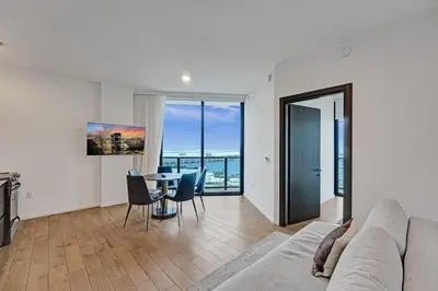a living room with a couch and a table with chairs at Miami 3BR Retreat City and Bay Views in Miami