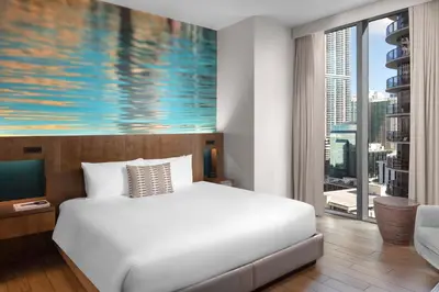 a bedroom with a white bed and a large window at EAST Miami in Miami
