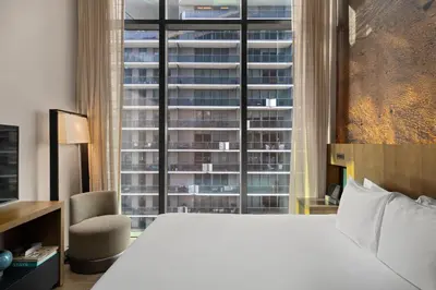 a bedroom with a large bed and a large window at EAST Miami in Miami