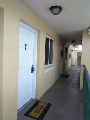 a hallway with a white door and a sign on the floor at Charming Kendall Home in Kendall