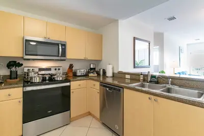 a kitchen with a sink and a stove top oven at Lovely 2 bedrooms 2 bathrooms Apt, Sleeps 4, Split King bed, Free Parking, Pet OK in Miami