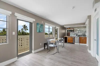 a kitchen and dining room with a table and chairs at Spacious Studio with Roof Top Pool & Bar in Miami Beach
