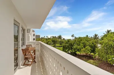 a balcony with chairs and a view of the ocean at Spacious Studio with Roof Top Pool & Bar in Miami Beach