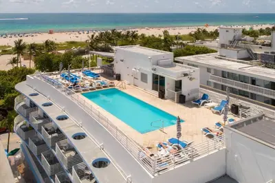 an aerial view of a resort with a pool and the beach at Ocean Drive Studio - Walk to the beach Rooftop Pool in Miami Beach