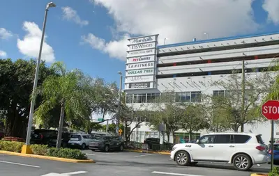 a white car is parked in front of a building at Large Apt, Parking, Split King Bed, Washer & Dryer in Miami