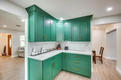 a kitchen with green cabinets and white counter tops at Backyard Oasis Fort Lauderdale Home Near Beach in Fort Lauderdale