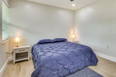 a bedroom with a bed with a purple comforter at Backyard Oasis Fort Lauderdale Home Near Beach in Fort Lauderdale
