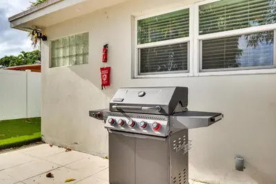 a barbecue grill in front of a house at Backyard Oasis Fort Lauderdale Home Near Beach in Fort Lauderdale