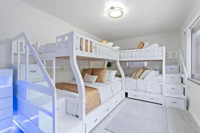 a white bunk room with white bunk beds at NEW Hollywood Luxury Villa, Game Room, Hot Tub 12, Fire Pit & BBQ in Hollywood