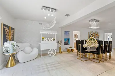 a living room with a table and a dining room at NEW Hollywood Luxury Villa, Game Room, Hot Tub 12, Fire Pit & BBQ in Hollywood