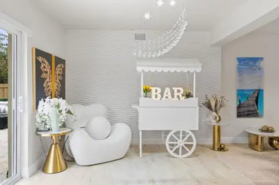 a white room with a bar cart and two tables at NEW Hollywood Luxury Villa, Game Room, Hot Tub 12, Fire Pit & BBQ in Hollywood