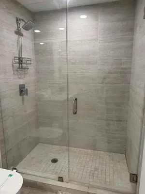 a shower with a glass door in a bathroom at Stylish 2BR Quadro Luxe Stay in Design District in Miami