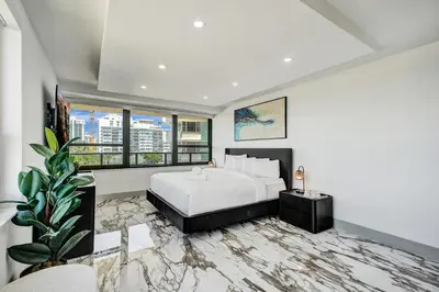 a bedroom with a bed and a potted plant at Luxury Beachside 3BR 3BA Condo Resort Amenities Pools Gym and Sauna 620 in Miami Beach