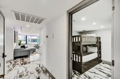 a bedroom with a bunk bed and a living room at Luxury Beachside 3BR 3BA Condo Resort Amenities Pools Gym and Sauna 620 in Miami Beach