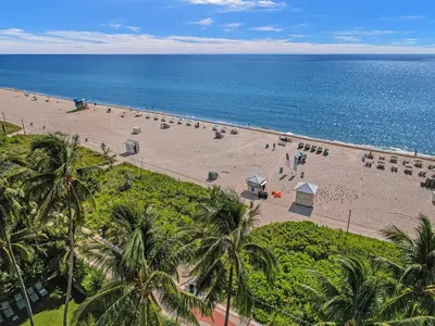 an overhead view of a beach with palm trees and the ocean at Oceanside Paradise Escape Spacious and Scenic Resort amenities Pools Bar Sauna 1514 in Miami Beach