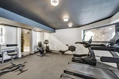 a gym with treadmills and elliptical machines at Modern Beach Retreat 2BR and 2BA Pools, Sauna, Gym Oceanfront Building 1615 in Miami Beach