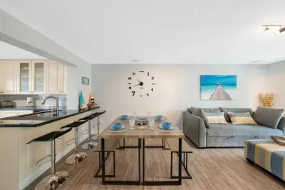 a kitchen and living room with a couch and a table at Waterfront Retreat Home Dania Beach in Dania Beach