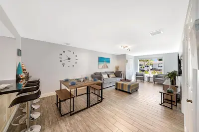a living room with a couch and a table at Waterfront Retreat Home Dania Beach in Dania Beach