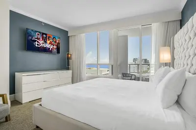 a bedroom with a large white bed and a large window at FontaineBleau Suite Ocean View in Miami Beach